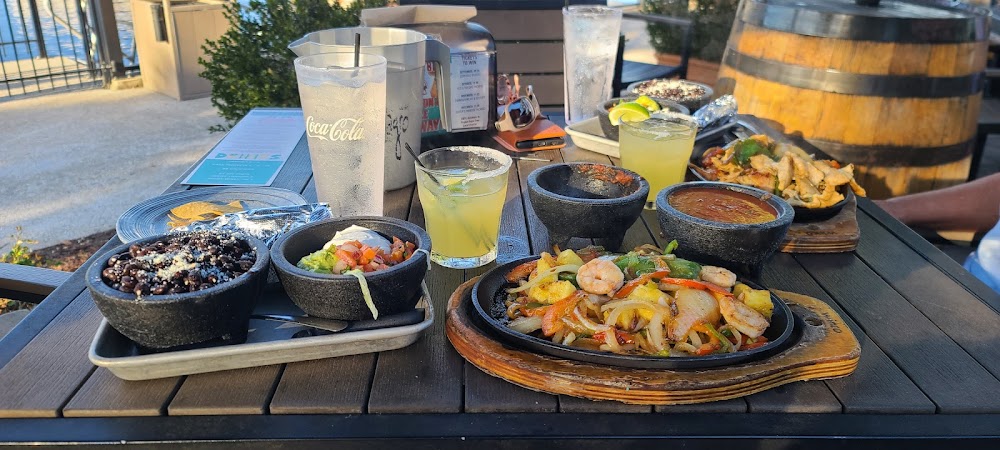 Taco Mundo Kitchen y Cantina signature dishes Trio Fajitas, Bbq Southern Brisket Quesadillas, A La Plancha Ground Beef Rice Bowl.